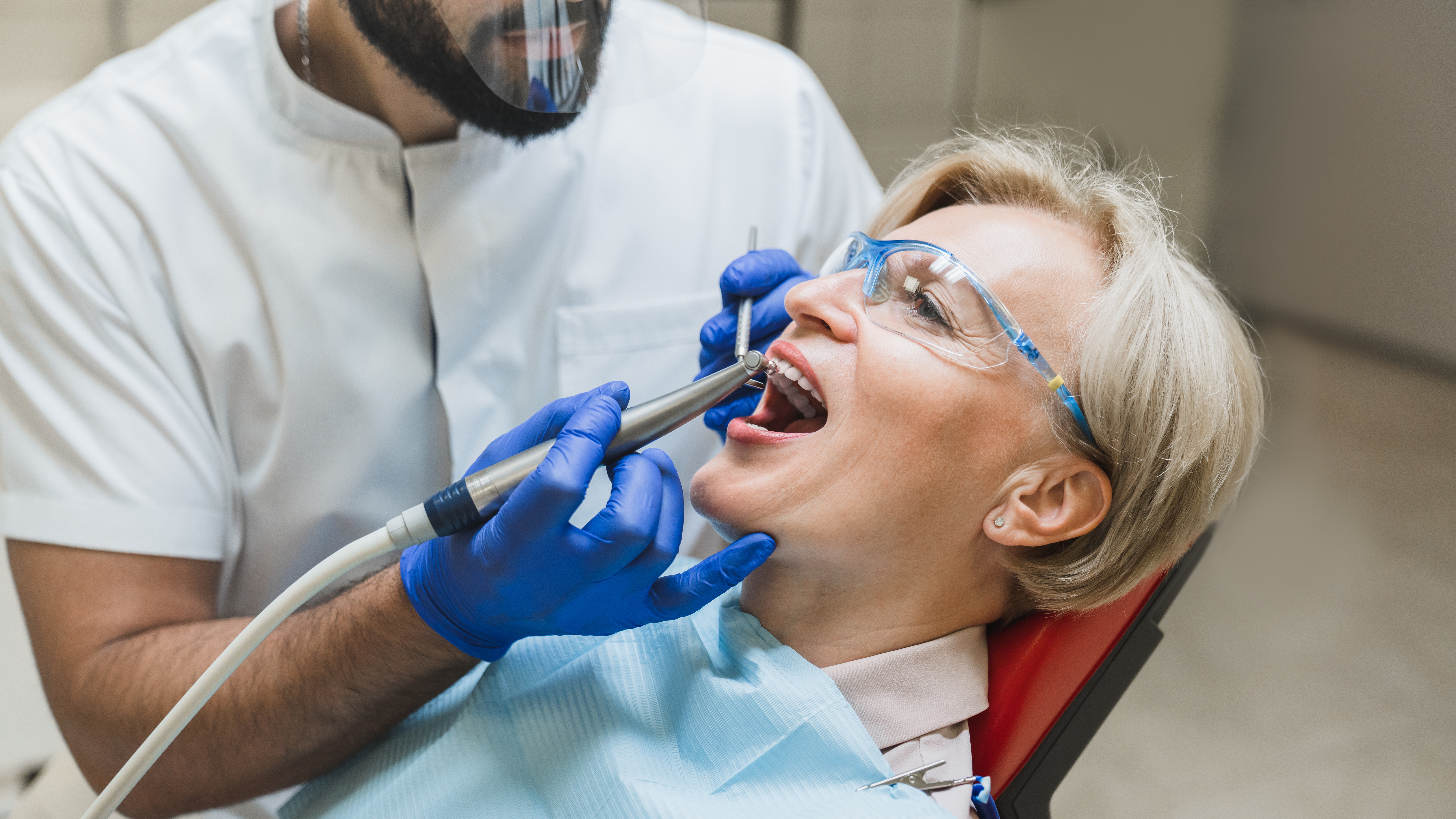 Male orthodontist checkup. Perfect ideal healthy smile. Stomatological dental equipment, dentist whitening filling tooth teeth of female patient at dental hospital