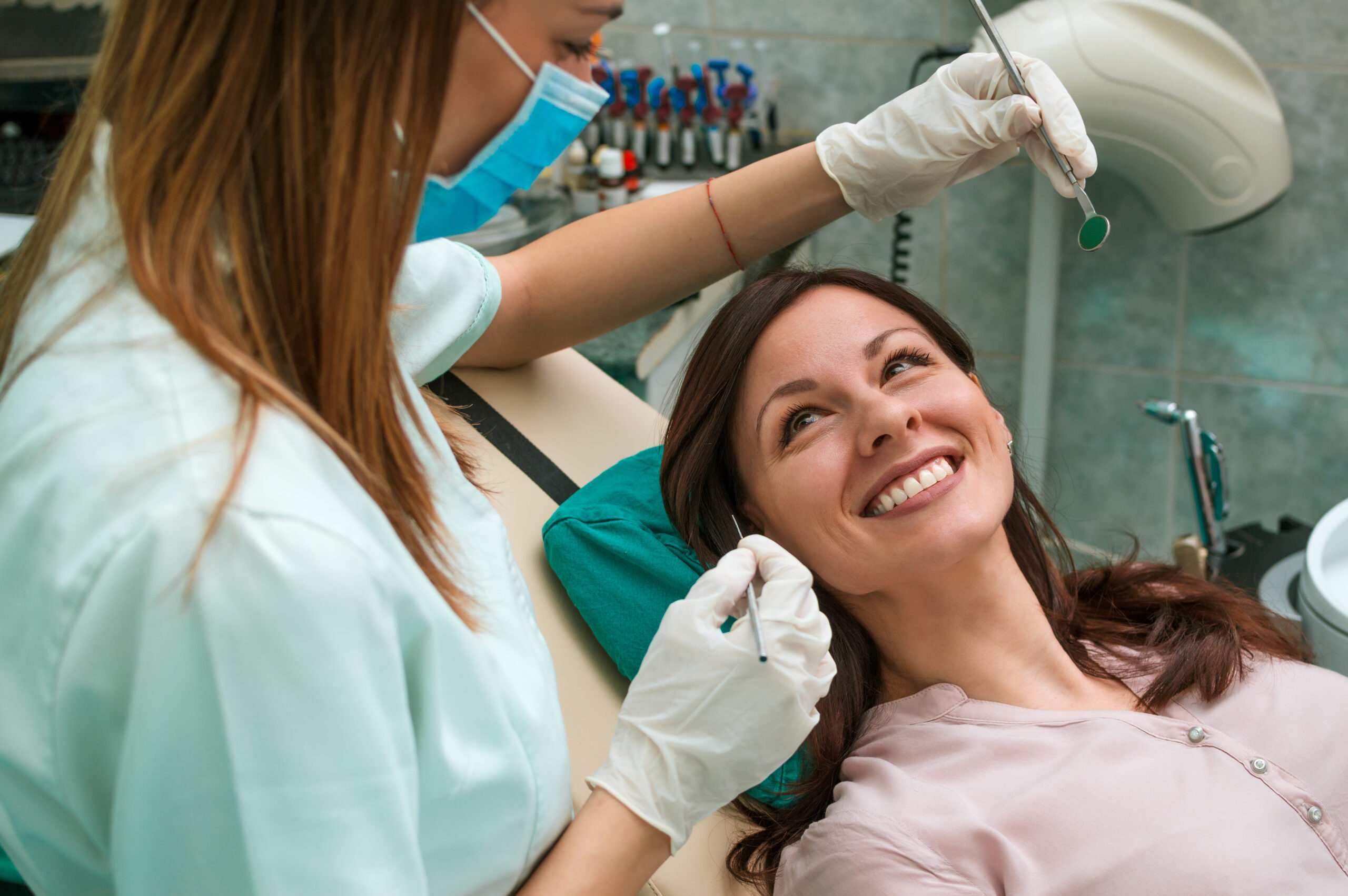 Female patient with dentist looking happy and smiling